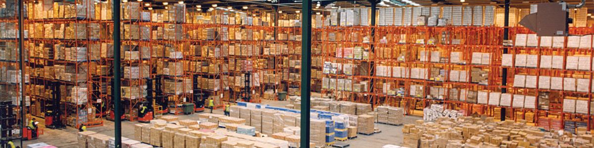 Rows of pallet racking stacked with cartons inside a large food distribution warehouse.